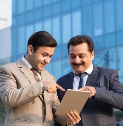 Two men looking at a tablet