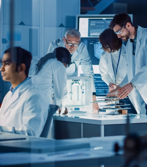 A  group of people in lab coats looking at a machine