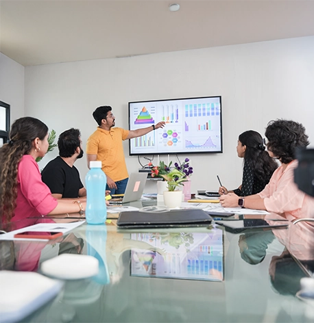 A  group of people in lab coats looking at a machine